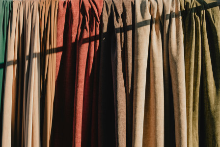 Different colours of curtains made from same textile.