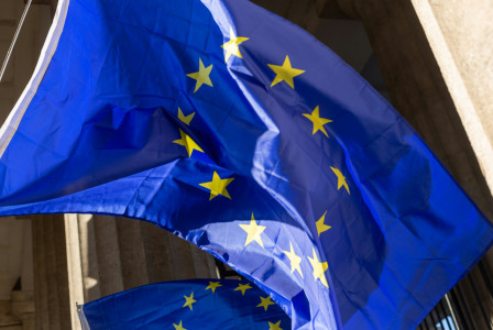 Two EU flags in front of a building. 