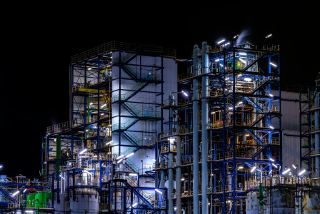 The photo presents an industrial facility at night.