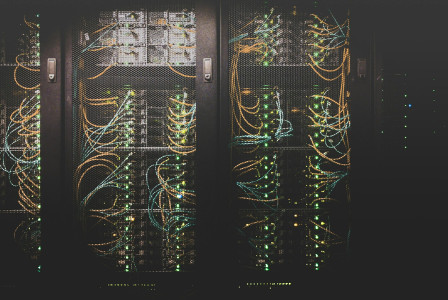 The photo presents server racks and network equipment in a data centre.