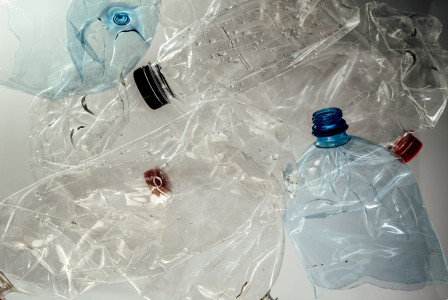 The photo presents crushed plastic bottles.