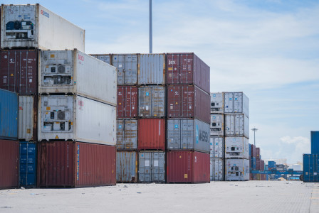 The photo shows a number of colourful containers waiting at the port for onward transport.