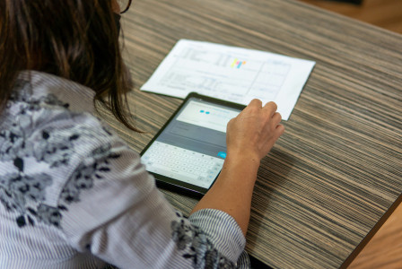 The photo shows lady using tablet.