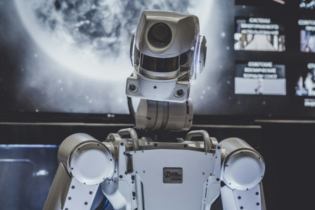 The photo shows a white humanoid robot.