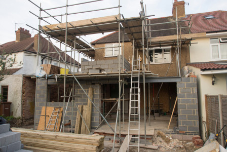 The picture describes a residential building extension and renovation project under construction.