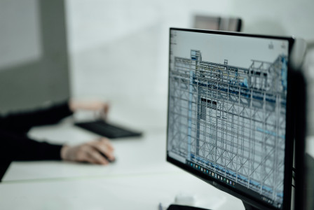 The picture shows a computer monitor displaying a Building Information Modeling (BIM) software.