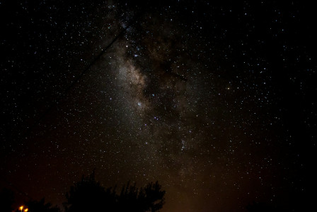 The photo shows the Milky Way in a star-filled night sky.