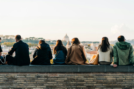 The photo shows tourists and locals mingle at sunset in Giardino degli Aranci in Rome, Italy