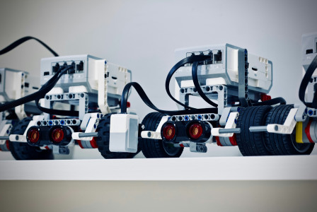 The picture shows a row of small educational robots built from modular components.