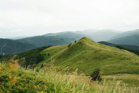 The photo shows green hills and mountains.
