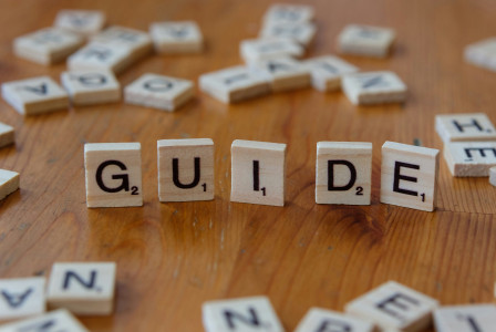 A graphic presenting the guide word built from wooden blocks.