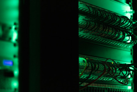 The photo presents network cables in a server room.