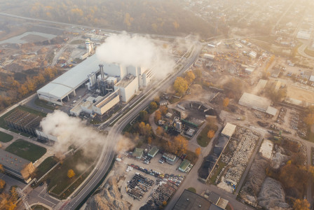 This picture shows an aerial view of a large industrial complex, surrounded by roads, storage areas, trees, and other industrial facilities.