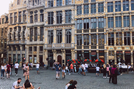 An illustrative photo of people sitting on the ground in Belgium