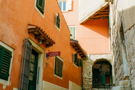 An illustrative photo of a coastal town with terracotta-roofed buildings and a marina