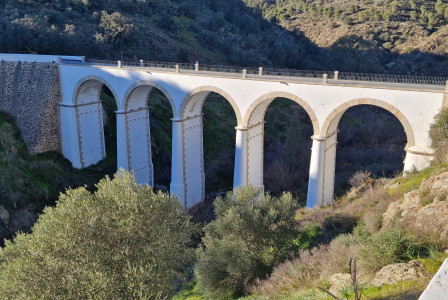 An illustrative photo of a bridge built into the side of a mountain