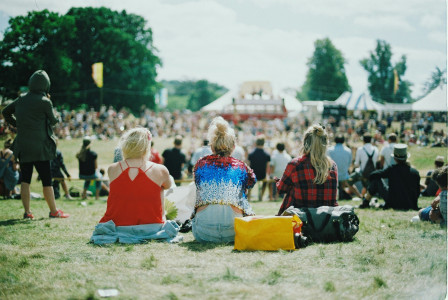 An illustrative photo of a group of people on grass field