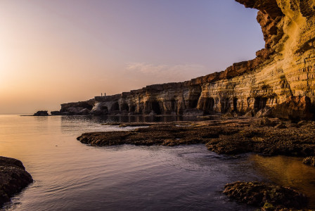 An illustrative photo of a serene coastal scene during sunset in Cyprus