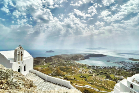 An illustrative photo of white building on rocky shore
