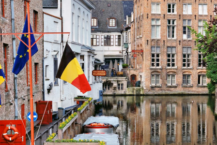 An illustrative photo of a tranquil canal scene in a Belgium city