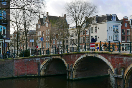 Photo by Unsplash An illustrative photo of a bridge over a river with buildings in the background