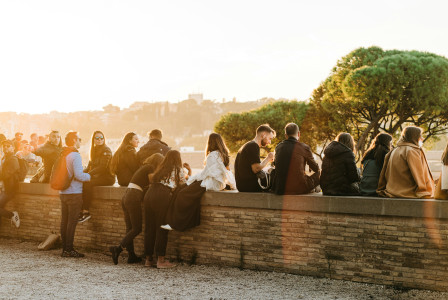 An illustrative photo of people sitting near the river