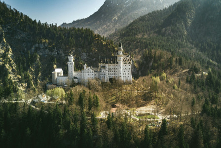 An illustrative photo of castle near the mountain.