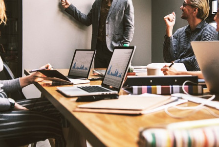 An illustrative photo of a group of individuals in a business meeting.