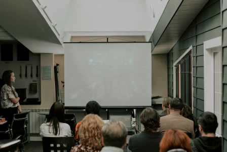 An illustrative photo of a group of people listening to the presentation