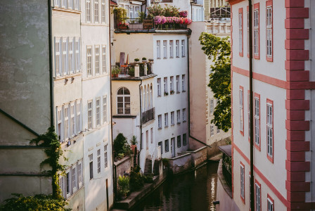 An illustrative photo of a cityscape with a narrow water canal