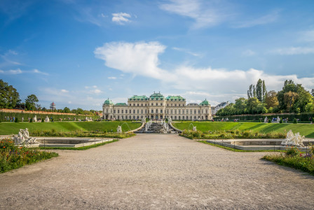 An illustrative photo of a large building with a fountain