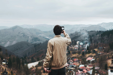 An illustrative photo of a man taking a photo of city.