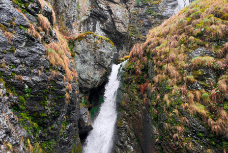 An illustrative photo of a waterfall in the middle of a canyon