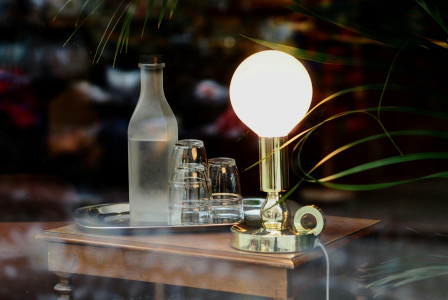 An illustrative photo of a lamp and glasses with water on the table