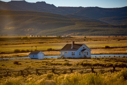 An illustrative photo of small houses near mountains.