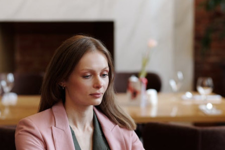 An illustrative photo of a woman types on her laptop