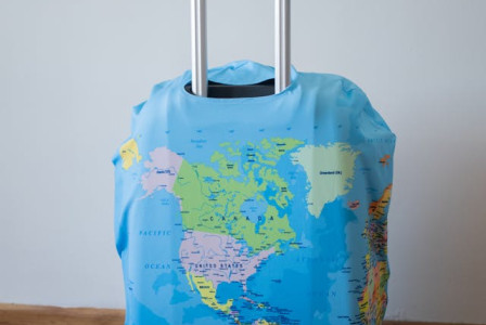 An illustrative photo of a suitcase with world map