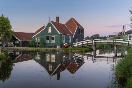 Photo by Pexels An illustrative photo of a green house beside body of water.