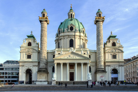An illustrative photo of a white concrete church in Vienna.