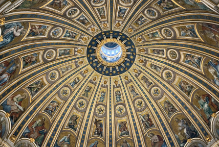 An illustrative photo of a majestic dome ceiling with fresco paintings in a Catholic cathedral