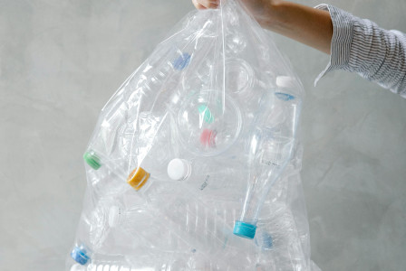 Photo by Pexels An illustrative photo of an anonymous person with a bag of plastic bottles
