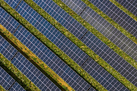 Photo by Unsplash An illustrative photo of a field with solar power plants