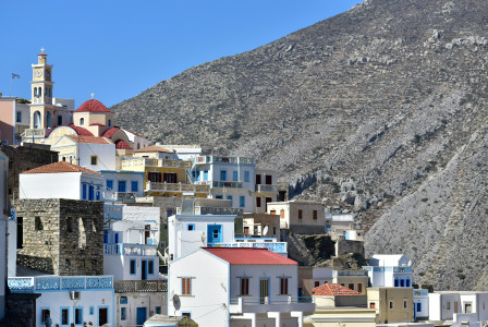 An illustrative photo of a city with a mountain in the background.