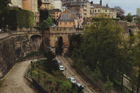 An illustrative photo of cars on street near the village