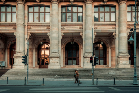 An illustrative photo of a person walking pass building