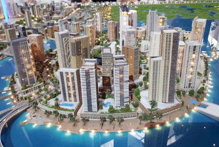 An illustrative photo of white high-rise buildings against a clear sky