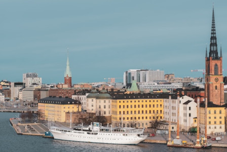 Photo by Unsplash An illustrative photo of a large white boat floats on a calm body of water