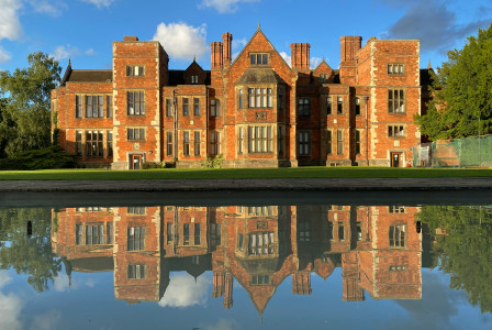 An illustrative photo of brown building near body of water