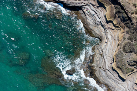 Photo by Unsplash An illustrative photo of a brown rock formation beside body of water