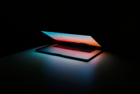 An illustrative photo of a gray and black laptop on surface